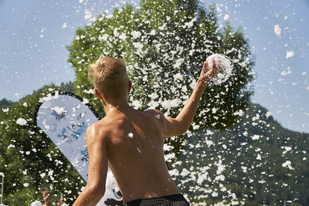 Guest throwing a snowball in the summer sun