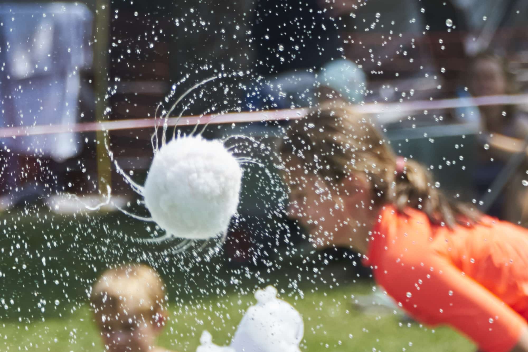 Snowball flying through water spray